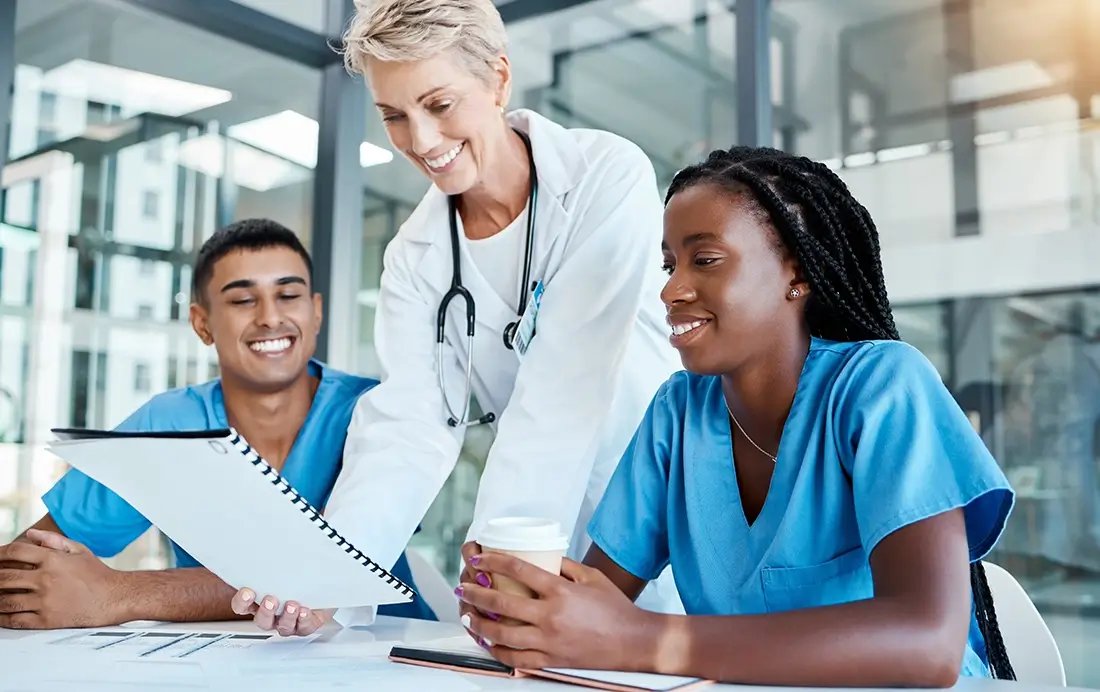 healthcare workers reviewing a report, aco, health management company, Center for Medicaid and Medicare